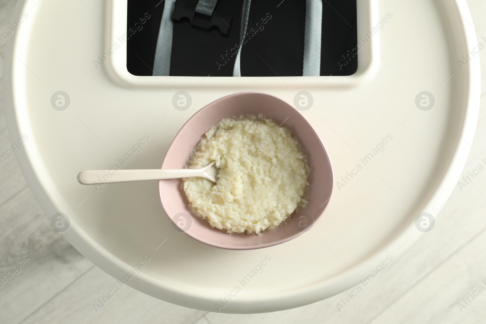 Photo of Baby high chair with healthy food, top view