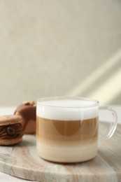 Photo of Aromatic coffee in cup and tasty macarons on table