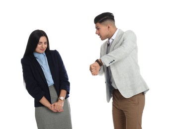 Photo of Businessman pointing on wrist watch while scolding employee for being late against white background
