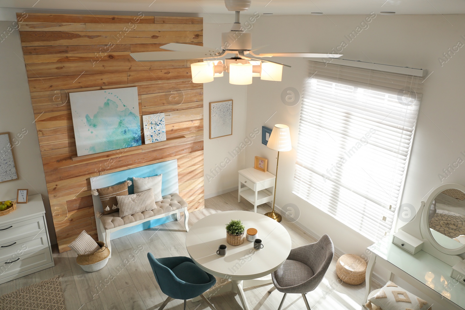 Photo of Stylish room interior with modern ceiling fan, view from above