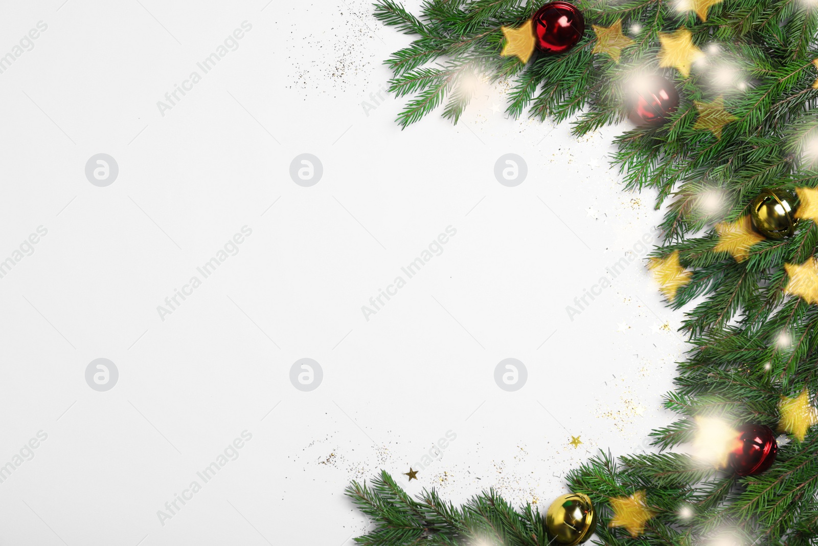 Photo of Christmas greeting card design. Flat lay composition with fir tree branches and festive decor on white background, space for text