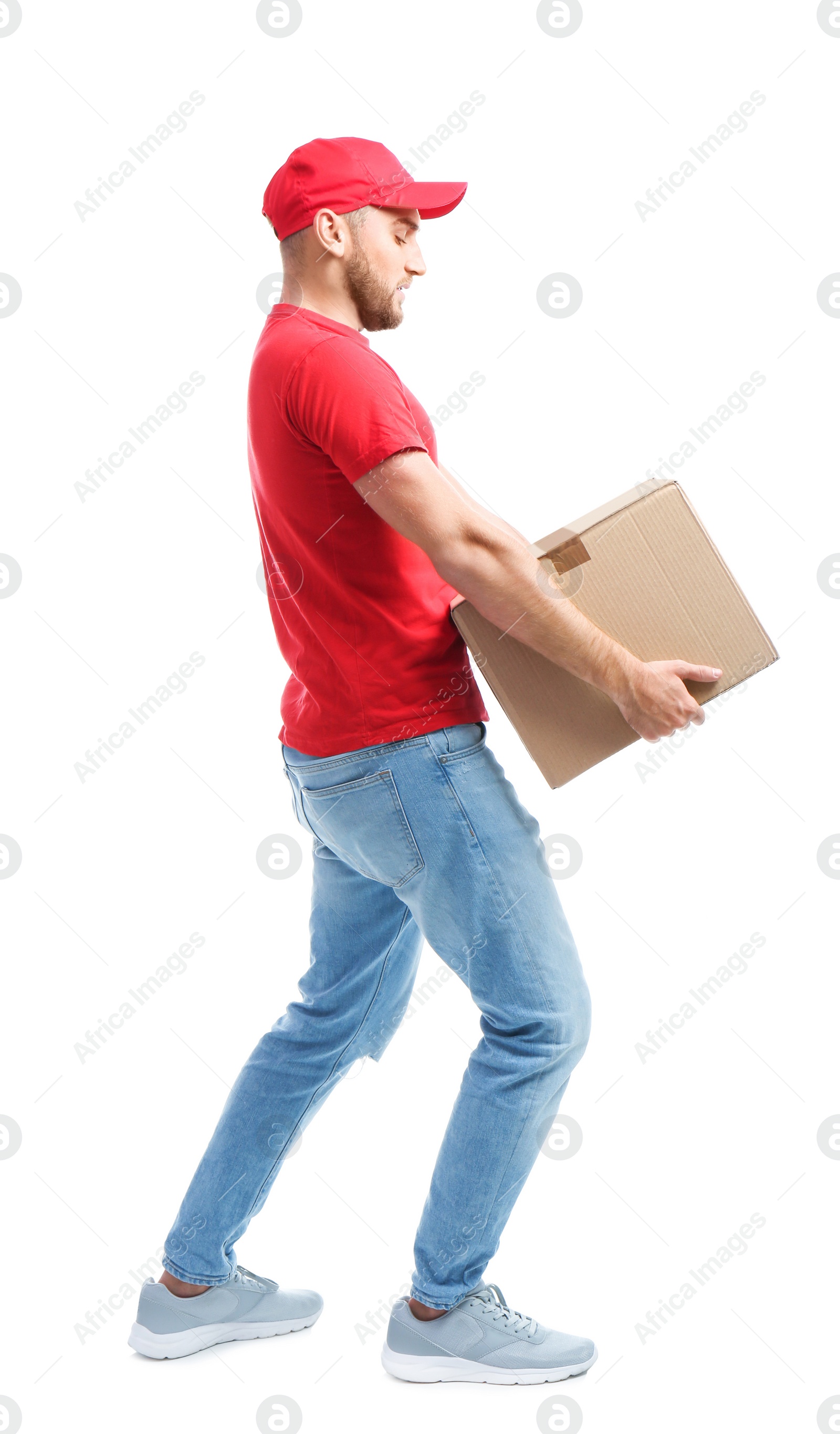 Photo of Full length portrait of man in uniform carrying carton box on white background. Posture concept