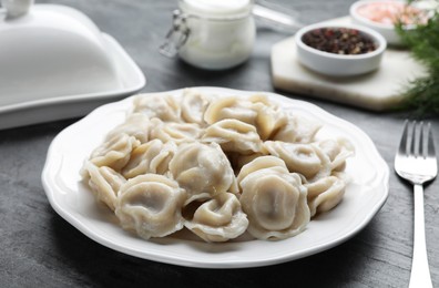 Tasty dumplings served on grey table, closeup