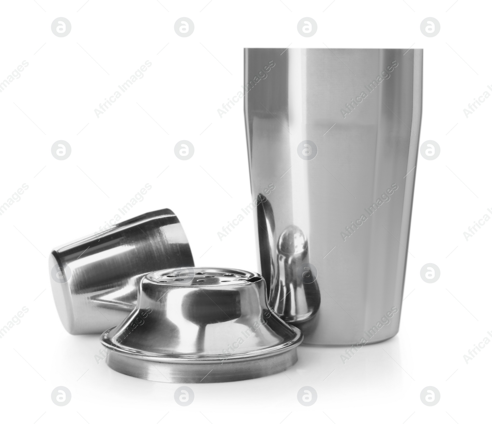 Photo of Metal cocktail shaker, strainer and cup isolated on white