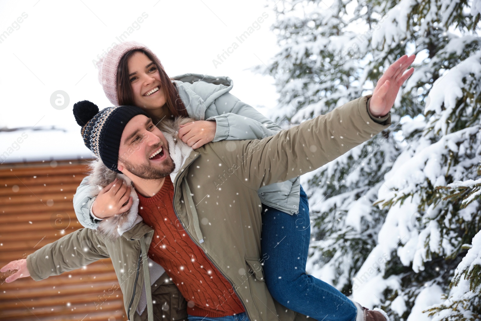 Photo of Lovely couple spending time together on snowy day. Winter vacation