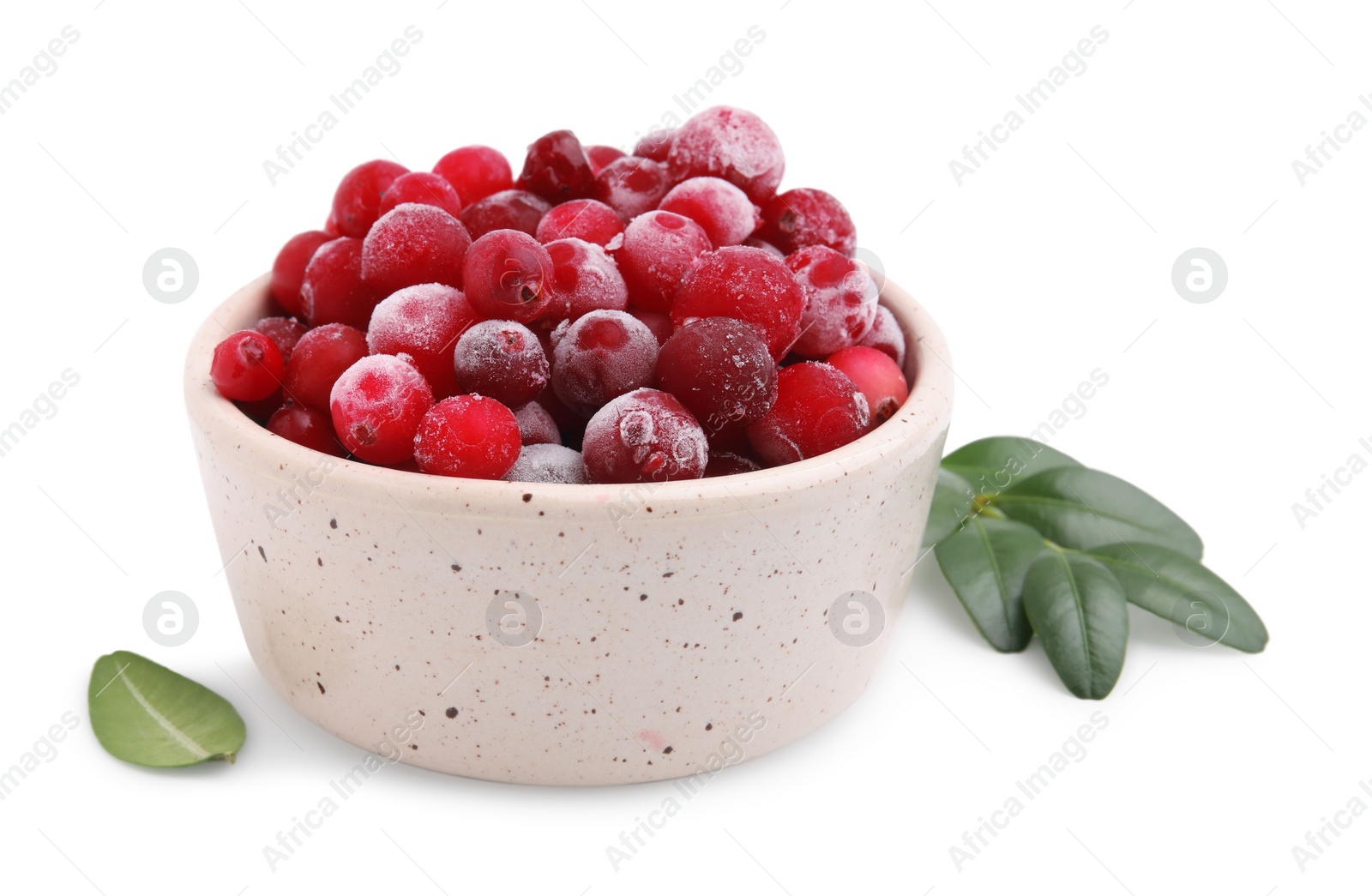 Photo of Frozen red cranberries in bowl and green leaves isolated on white