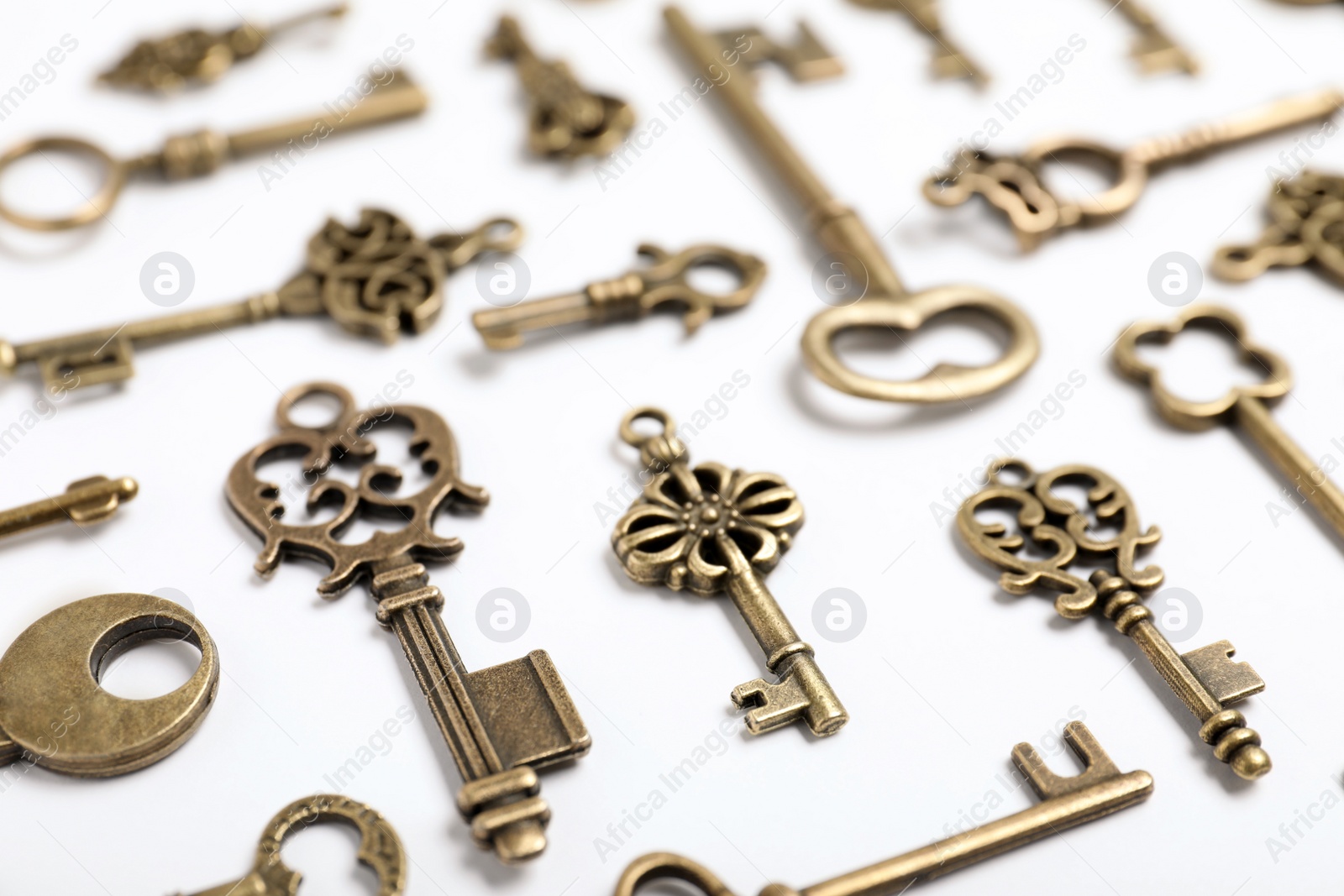 Photo of Bronze vintage ornate keys on white background