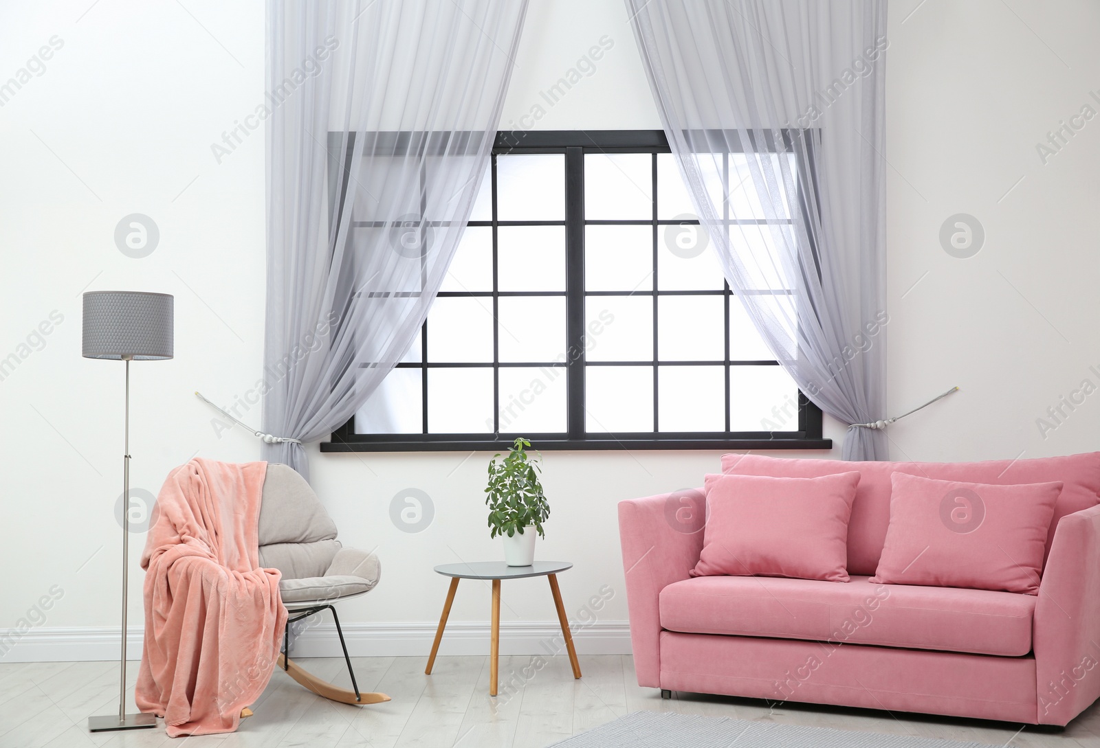 Photo of Modern furniture and window curtains in stylish room interior