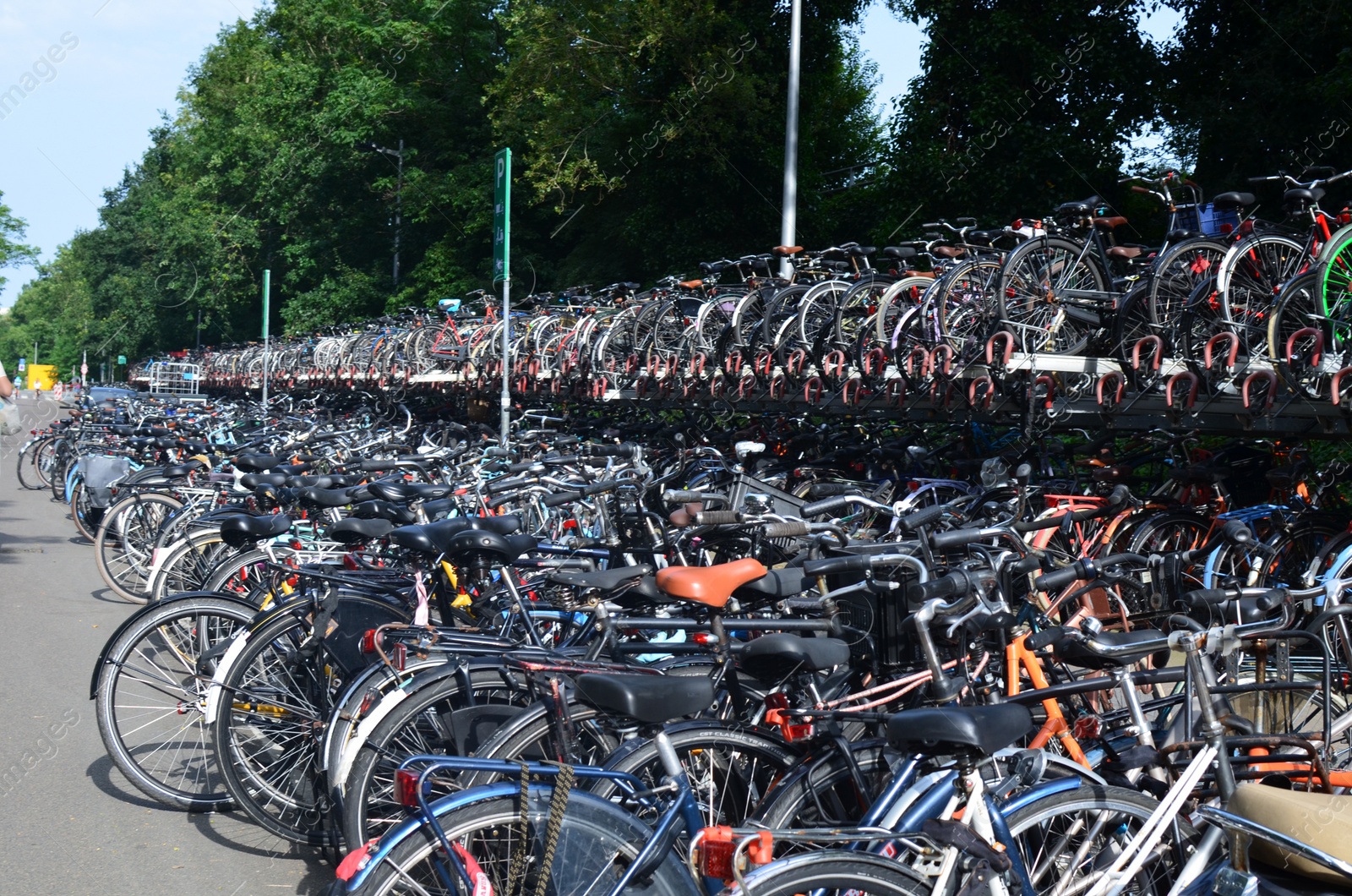 Photo of Many modern bicycles parked on city street