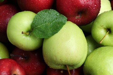 Photo of Fresh ripe green and red apples with water drops as background, top view