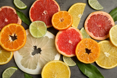 Photo of Different citrus fruits on grey background, top view