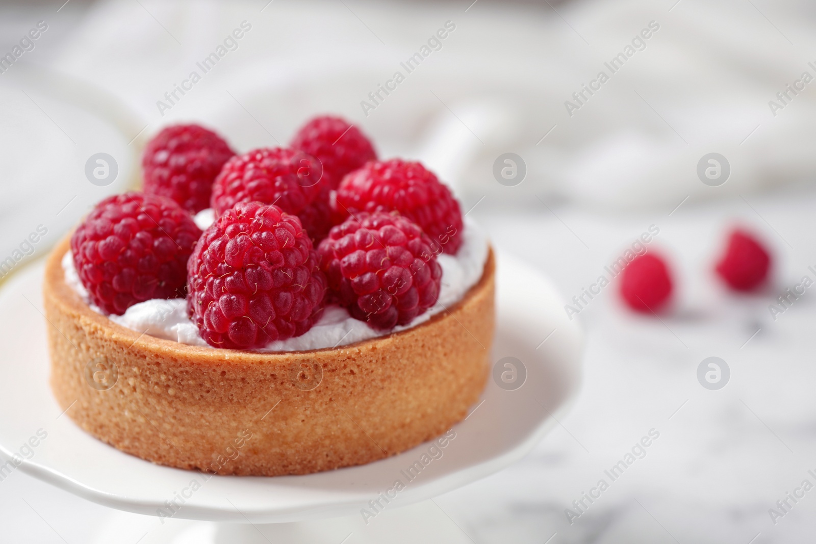 Photo of Cake stand with raspberry tart. Delicious pastries