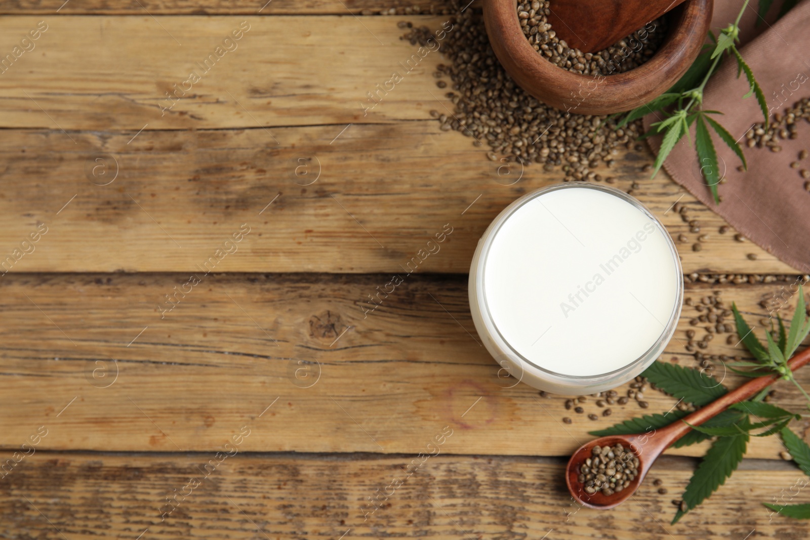 Photo of Flat lay composition with fresh hemp milk on wooden table. Space for text