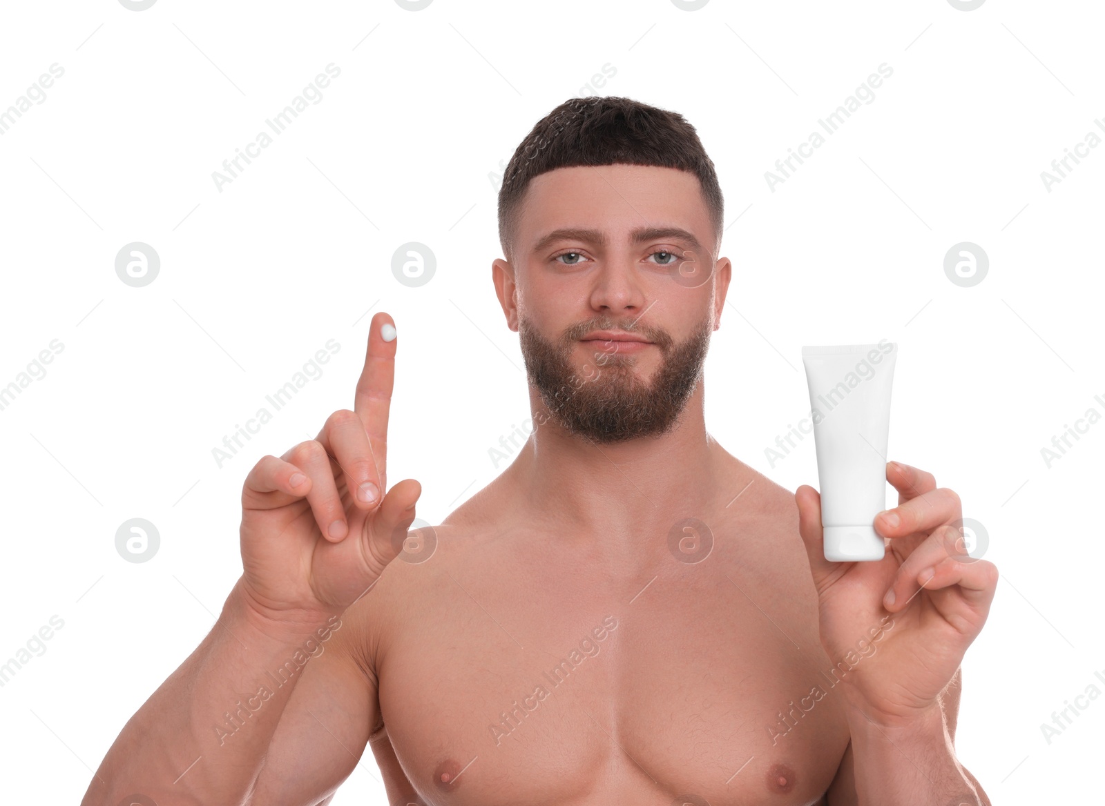 Photo of Handsome man with tube of body cream on white background