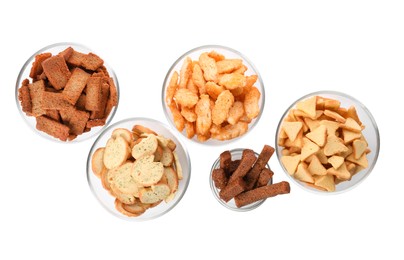 Photo of Different crispy rusks in bowls on white background, top view