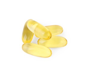 Many yellow vitamin capsules isolated on white, top view