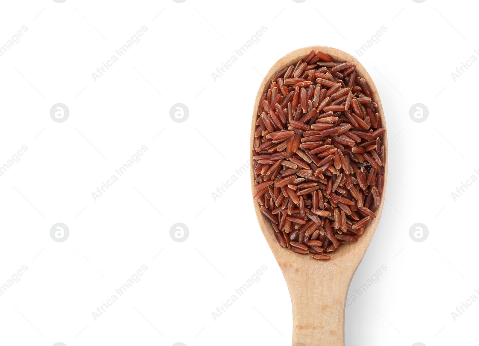 Photo of Wooden spoon with brown rice on white background, top view