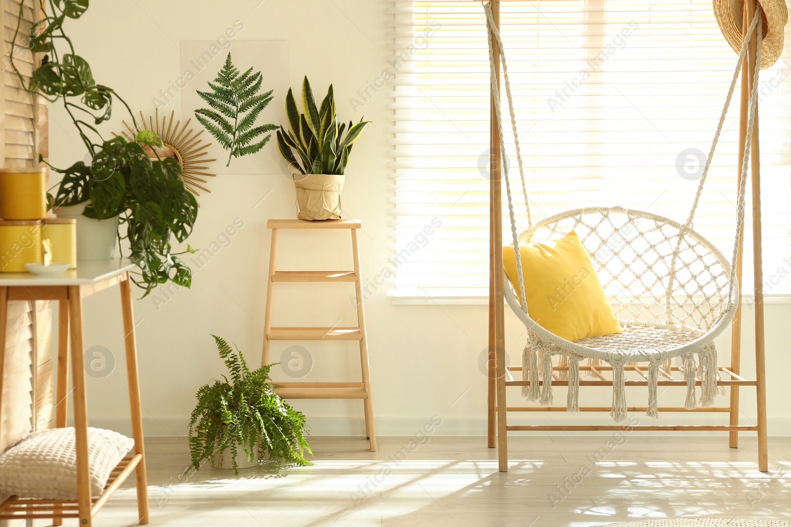 Photo of Comfortable hammock chair in stylish room. Home interior