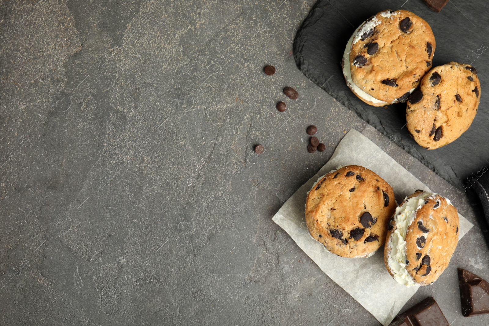 Photo of Sweet delicious ice cream cookie sandwiches served on table, flat lay. Space for text