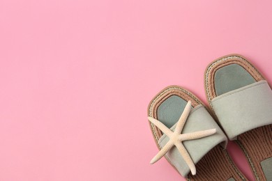 Photo of Pair of new slippers and starfish on pink background, flat lay. Space for text