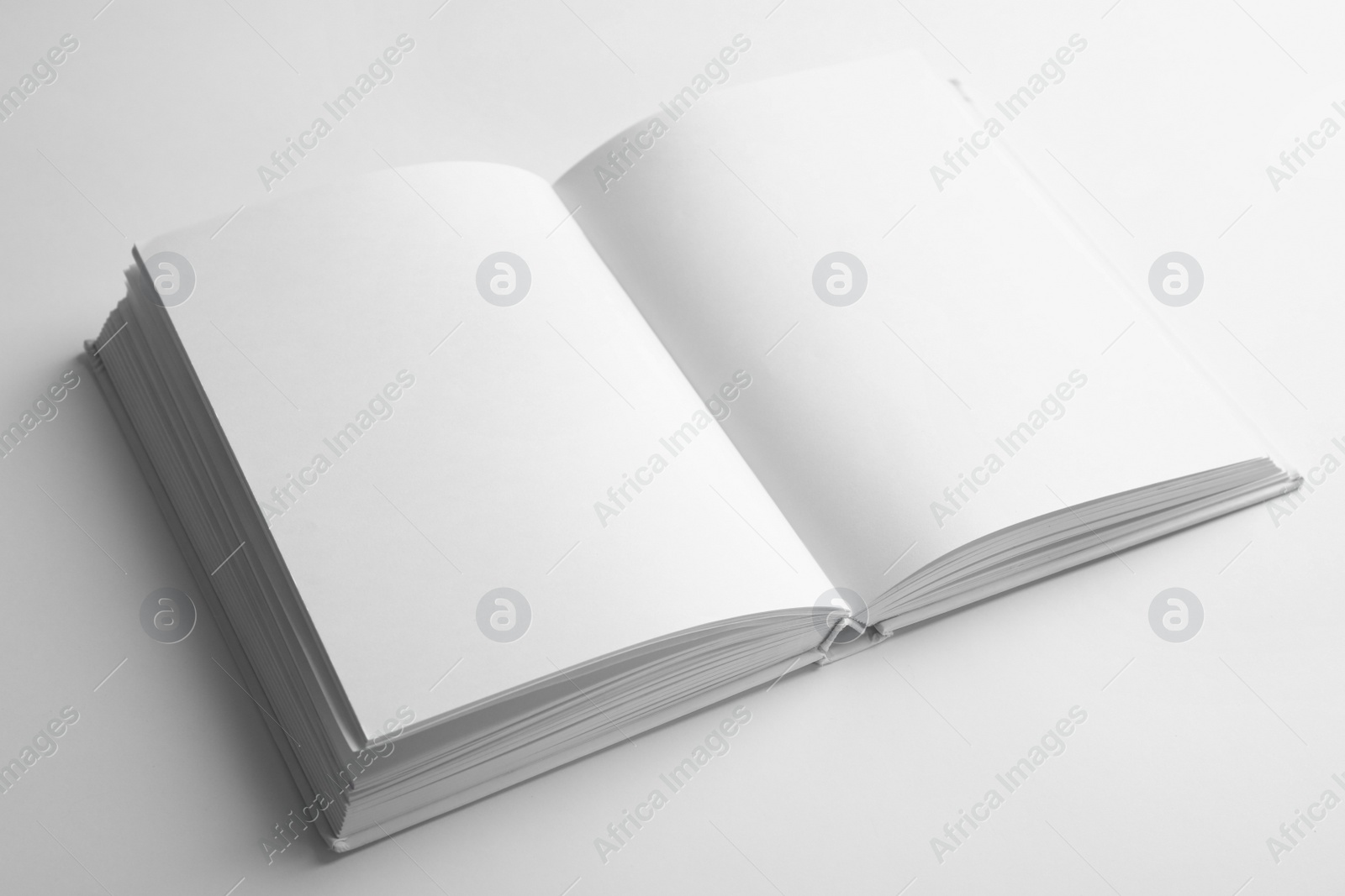 Photo of Open book with blank pages on white background. Mock up for design