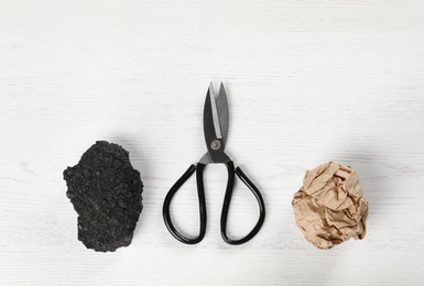 Flat lay composition with rock, paper and scissors on white wooden background