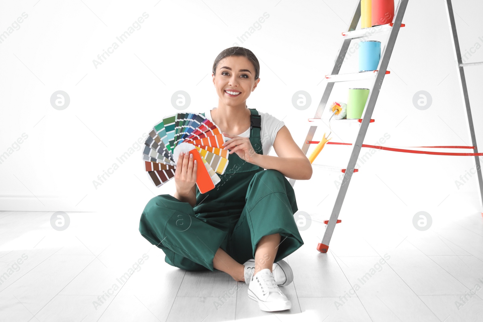 Photo of Female decorator with color palette indoors