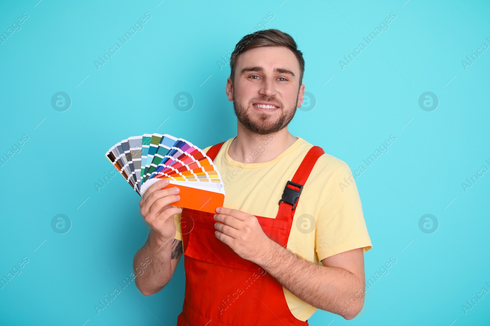 Photo of Male decorator with palette on color background