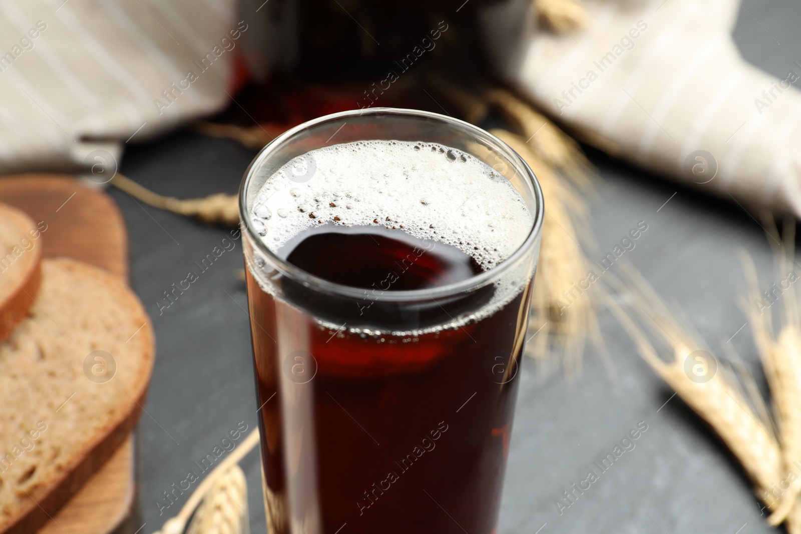 Photo of Glass of delicious kvass on table, closeup