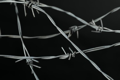 Metal barbed wire on black background, closeup