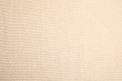 Photo of Beige soft cashmere fabric as background, closeup