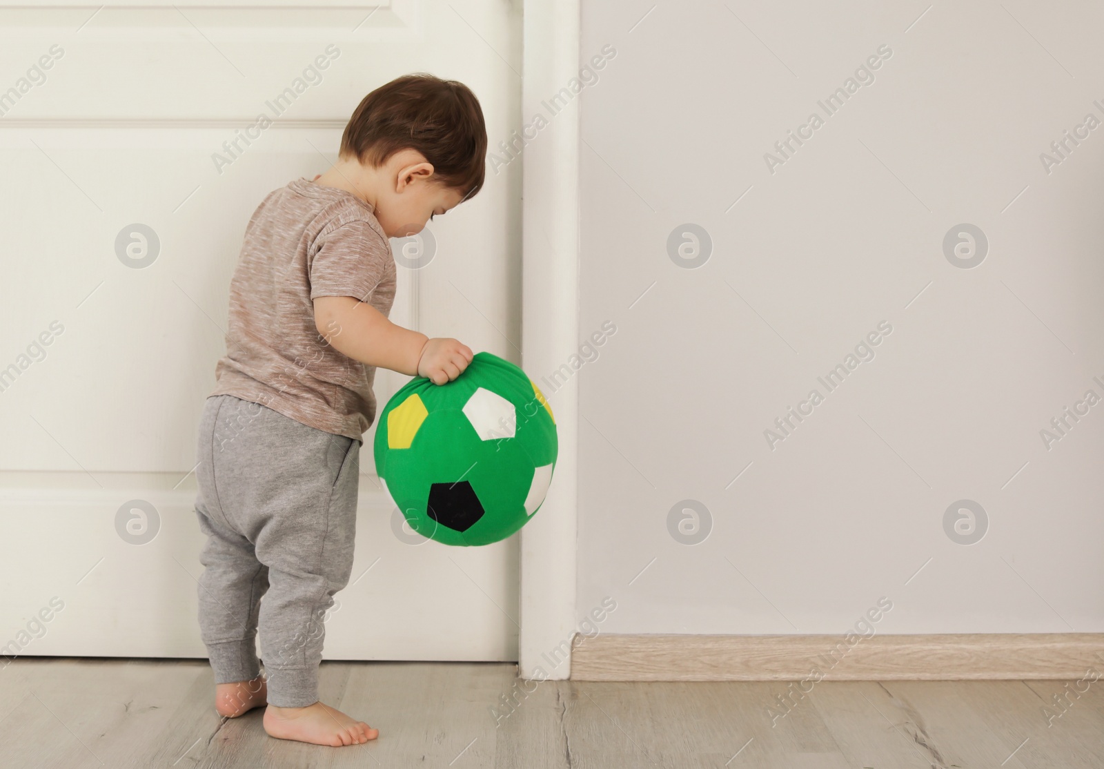 Photo of Cute baby learning to walk and playing at home