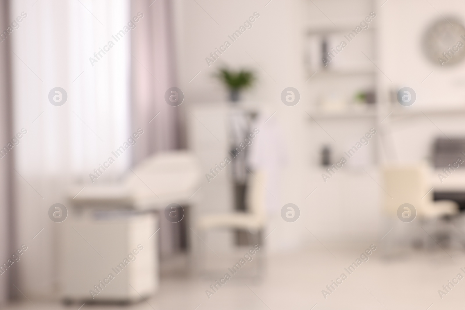 Photo of Blurred view of medical office interior with doctor's workplace