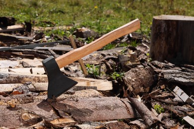 Photo of Axe and cut firewood outdoors. Professional tool