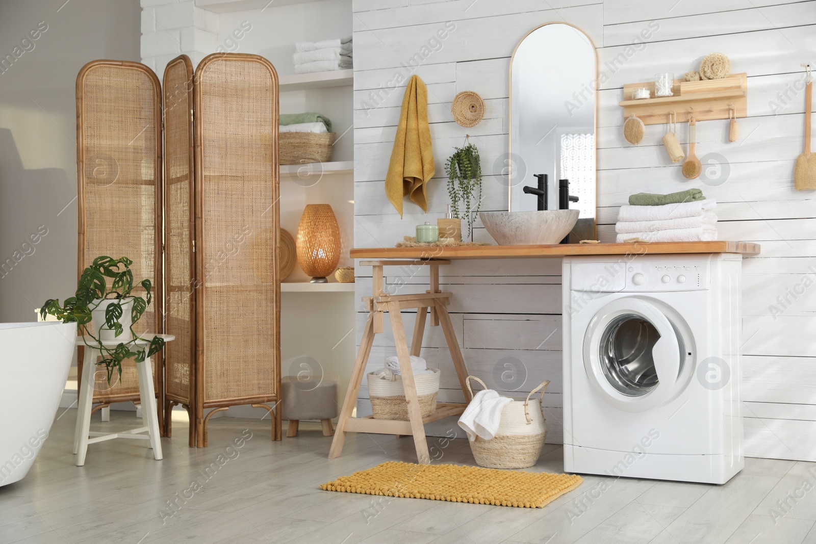 Photo of Stylish bathroom interior with modern washing machine