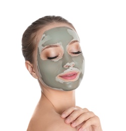 Beautiful woman with clay mask on her face against white background