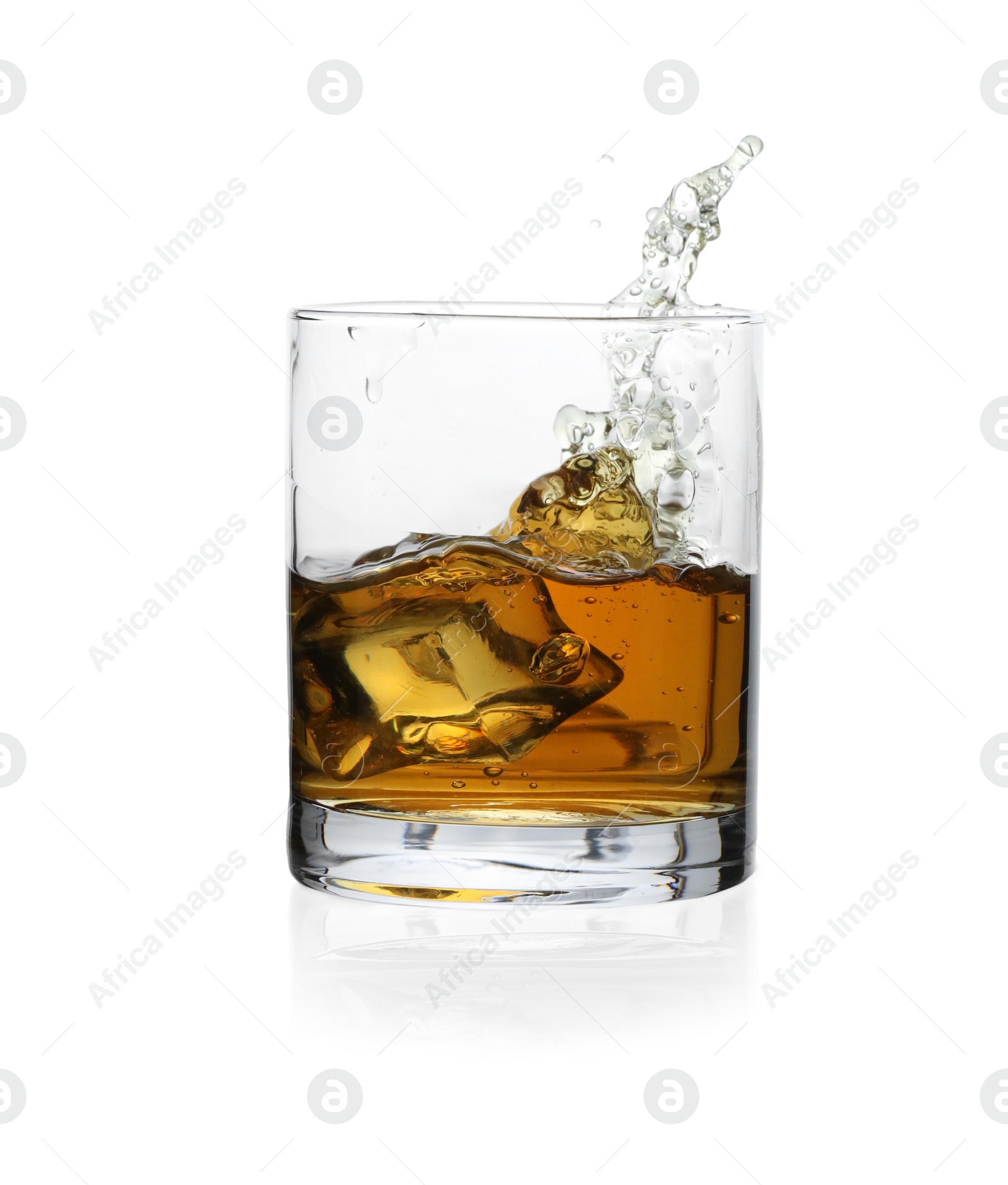 Photo of Whiskey splashing out of glass on white background