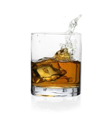 Whiskey splashing out of glass on white background