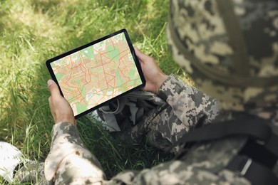 Photo of Soldier with backpack using tablet in forest, above view