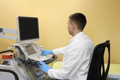 Photo of Doctor working with ultrasound machine in clinic
