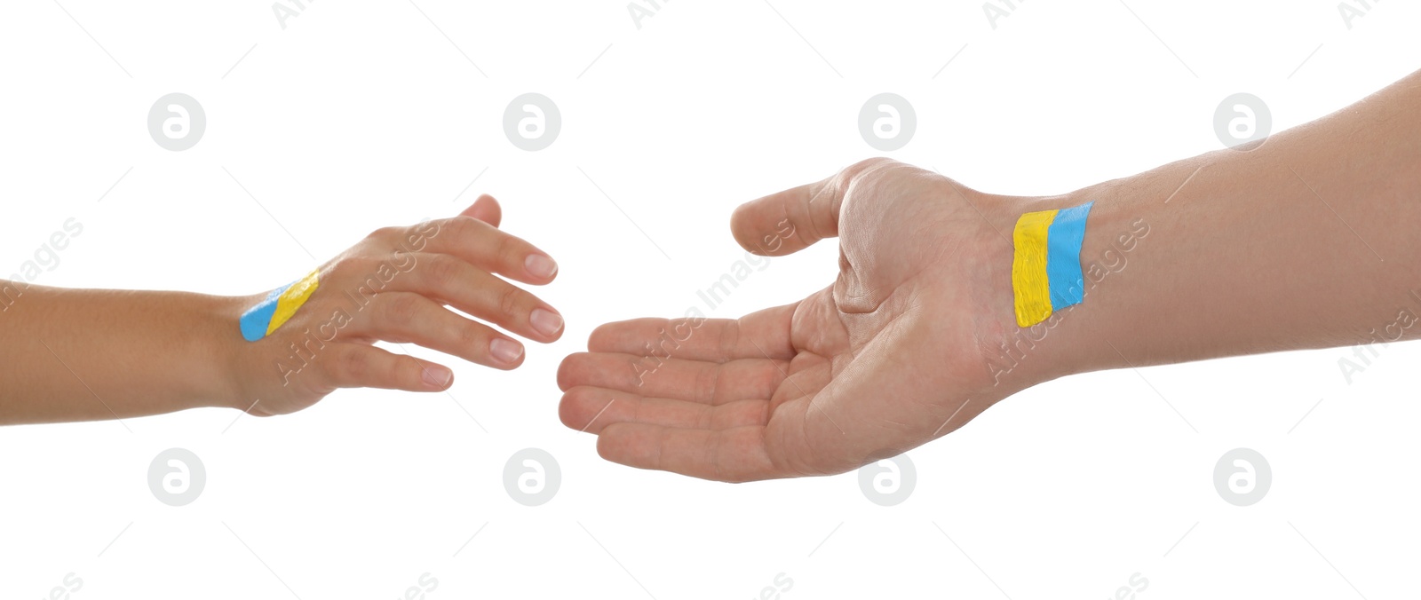 Photo of Man and woman with painted Ukrainian flags on their hands against white background, closeup