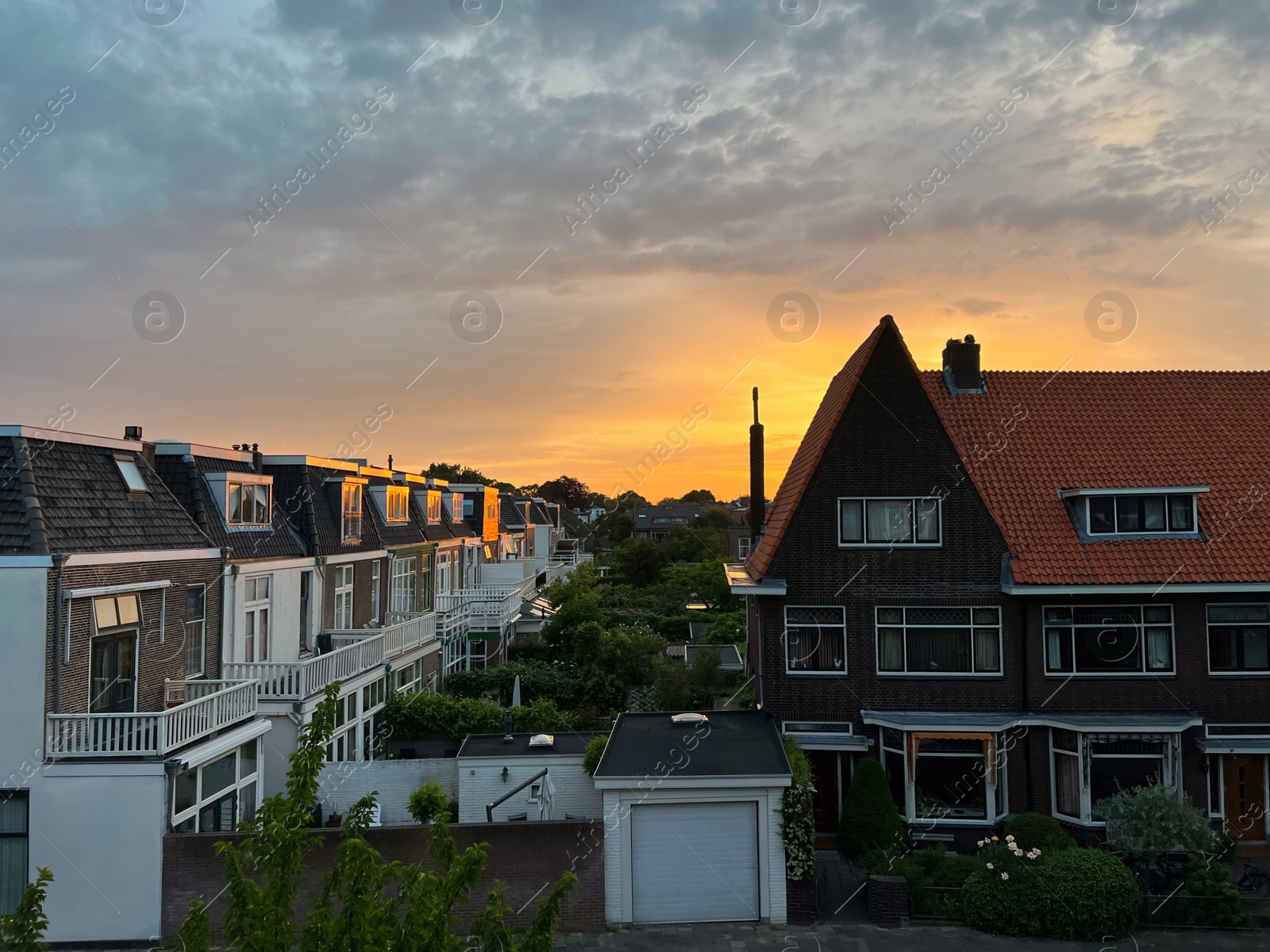 Photo of Picturesque view of city street with beautiful buildings at sunrise