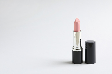 Image of Pale pink lipstick on light background. Space for text