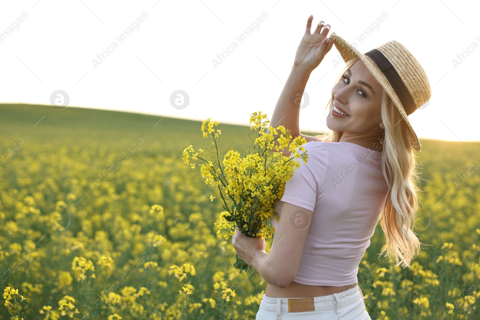 Photo of Portrait of happy young woman in field on spring day