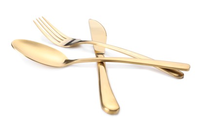 Shiny golden fork, knife and spoon isolated on white. Luxury cutlery set