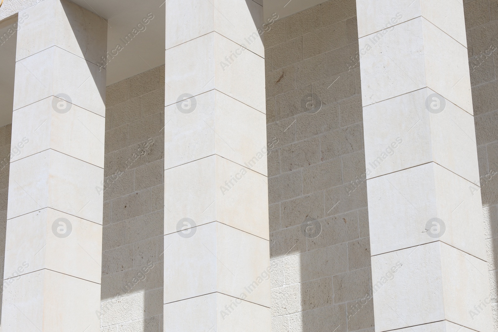 Photo of View of modern beige building with columns outdoors