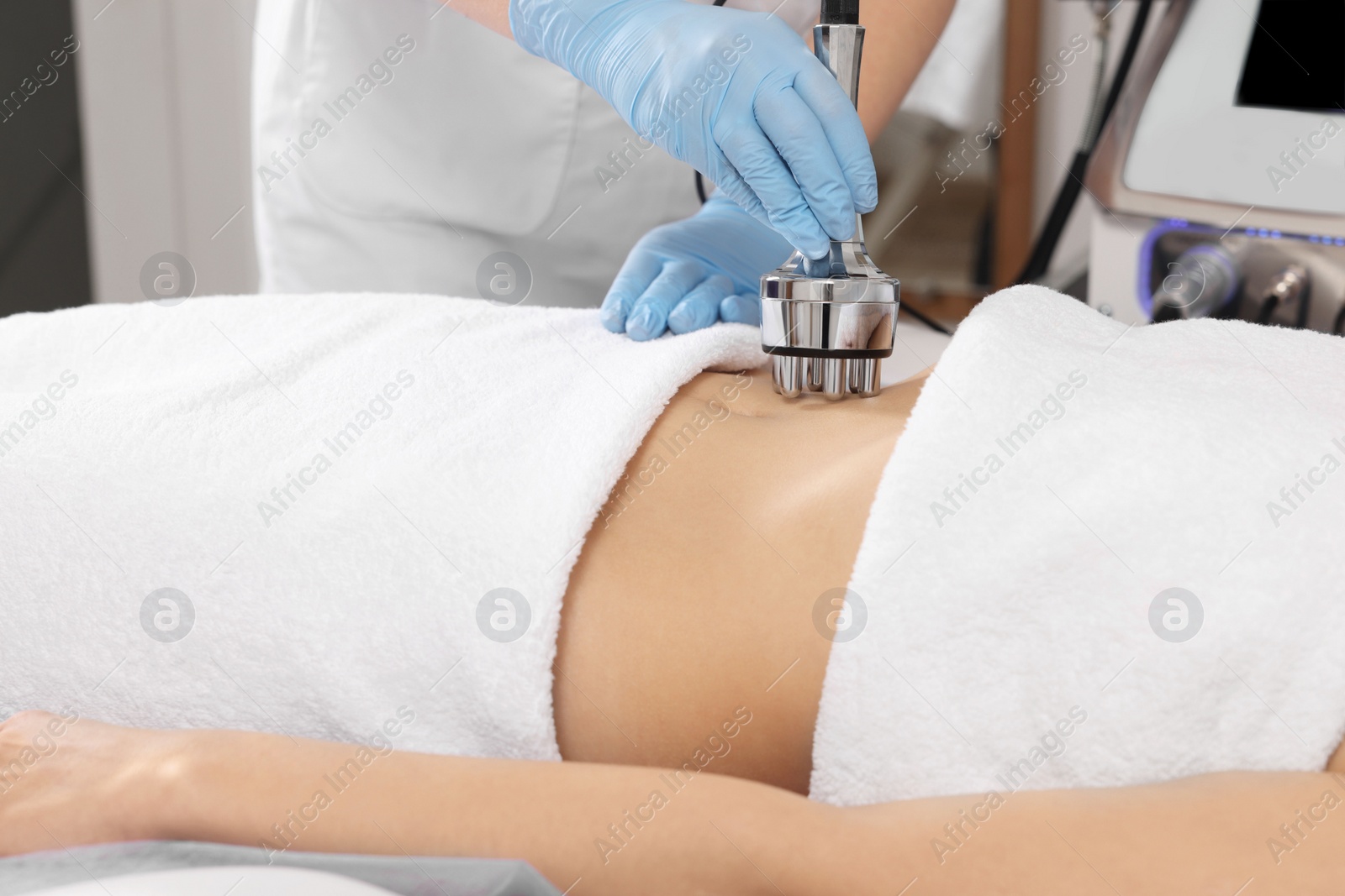 Photo of Woman undergoing radio frequency lifting procedure in beauty salon, closeup