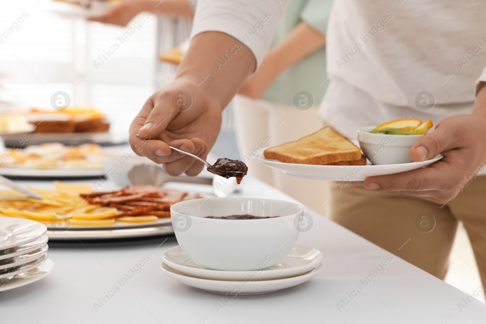 Photo of People near table with different dishes during breakfast, closeup. Buffet service