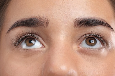 Photo of Young woman with beautiful eyelashes, closeup view