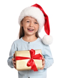 Happy little child in Santa hat with gift box on white background. Christmas celebration